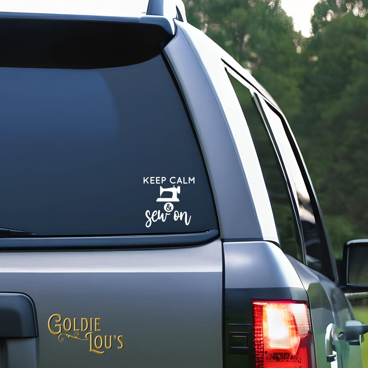 Keep Calm & Sew On Car Vinyl Decal on the rear window of a silver car