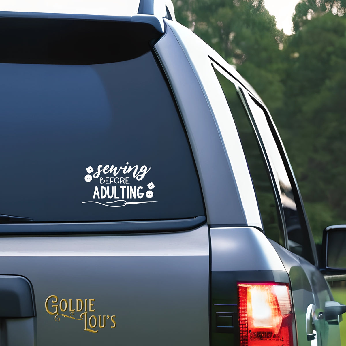 Sewing Before Adulting Car Vinyl Decal on the rear window of a silver car